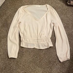 Medium cream long sleeve blouse.